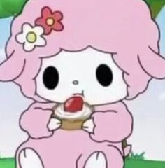 a cartoon character holding a cupcake in front of her face and sitting on the ground