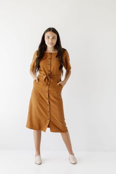 Introducing the 'Bronwyn' Tencel dress! This flattering dress features a button front detail and is finished off with a beautiful belt that ties together an entire look. Pair with low heels for an elevated and sophisticated office look! Exclusively designed by us with you in mind. 75% Tencel 25% Linen Hand Wash Cold Do Not Bleach Hang to Dry Low Iron if Needed Do Not Dry Clean Unlined Functional, nursing friendly buttons! FINAL SALE: NOT ELIGIBLE FOR RETURN OR EXCHANGE Model Height 5'7" | Wearin