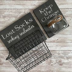 two books sitting on top of a wooden floor next to a wire basket filled with coins