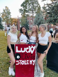 four girls are posing with a sign that says lucky u'm not stole my