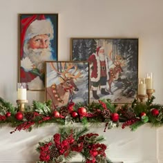 a mantel decorated with christmas decorations, candles and pictures on the wall above it