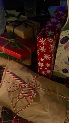 presents wrapped in brown paper and tied with twine on a plaid tablecloth covered table