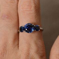 This is a gorgeous handmade creation. Its beauty is its simplicity & Elegance. The 8 mm round cut faceted lab sapphire and two 5mm lab sapphire is crafted in solid sterling silver and with rhodium plated. All item is sent in a beautiful gift box You can realize more lovely stuff clicking the link https://www.etsy.com/shop/knightjewelry?refshopsection_shophome_leftnav Please leave the correct address and you phone number for delivering successfully. Classic Sapphire Birthstone Ring With Gemstone, Elegant Three-stone Sapphire Ring, Timeless Lab-created Sapphire Promise Ring, Classic Sapphire Ring With Lab-created Gemstone, Timeless Sapphire Rings With Lab-created Sapphire, Classic Three Stone Jewelry With Lab-created Sapphire, Timeless Round Cut Sapphire Ring, Round Lab-created Sapphire Gemstone Jewelry, Classic Ethical Sapphire Ring