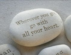 two rocks with the words wherever you go, go with all your heart