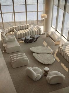 a large living room filled with lots of white furniture