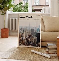 a new york newspaper sitting on top of a rug next to a table with books