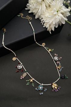 This necklace is a dainty, delightful piece. With a collection of quirky little unit, embellished with colorful stones and pearls, this necklace is perfect piece for the lovers of eccentric designs. Closure - Lobster Style Tip - Meet the perfect amalgam of poetic romance and the surrealism of fairy tales. Reminding us of clear starlit skies, magic and all the poems about love and passion, these designs are perfect for someone who wishes to add poetic details to their selections which are also re Temple Jewelry Style Jeweled Necklace As Gift, Jeweled Temple Jewelry Necklace As Gift, Temple Jewelry Style Necklace As A Gift, Multicolor Gemstone Kundan Necklace Gift, Multicolor Multi-stone Kundan Necklace For Gift, Multicolor Jeweled Bridal Necklace For Festive Occasions, Festival White Gemstone Necklace, Handmade Multicolor Kundan Necklace For Party, Multicolor Temple Jewelry Necklaces For Gift