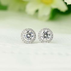 Showcased here is classic round halo studs earrings.  Center set in round cut 1.0ct.  There are also small stone halo set around the center stone.  Great gift for yourself or for friends! ITEM SPECIFICATIONS: Metal Type: Solid 925 Sterling Silver Metal Stamp: 925 Plating: Rhodium  Main Stone Dimensions: Round 6.5mm Approximate Center stone: 1 Carat (each) Approximate Carat Total Weight (CTW): 1ct cener, 1.16 carat total per pc (in par 2.32 Carat Total) Dimension:  Dimension with Halo approx. 10m Elegant Lab Grown Diamond Cluster Earrings As Gift, Elegant Lab Grown Diamond Cluster Earrings For Gifts, Elegant Wedding Earrings With Lab Grown Diamonds, Anniversary Cubic Zirconia Halo Earrings, Anniversary Halo Cluster Earrings With Cubic Zirconia, Diamond Halo Bridal Earrings For Anniversary, Halo Cubic Zirconia Earrings For Anniversary, Fine Jewelry Bridal Earrings With Halo Setting, Cubic Zirconia Cluster Earrings With Halo Design For Anniversary