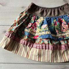 Matilda Jane Floral Apron Skirt. Pull on brown plaid design too with floral patterns and stripes at the bottom of skirt. Size 2 years, 80% cotton, 38 % nylon and 2 % spandex. Excellent used condition. Spring Brown Patchwork Skirt, Cotton Skirted Bottoms With Patchwork, Multicolor Cotton Ruffled Skirt, Brown Cotton Gathered Skirt Bottoms, Brown Cotton Bottoms With Gathered Skirt, Brown Cotton Gathered Skirt, Brown Cotton Mini Skirt, Girls Skorts, Apron Skirt