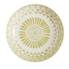 a yellow and white decorative object on a white background with an intricate design in the center