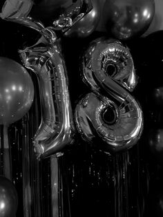 black and white photograph of balloons and the number eight