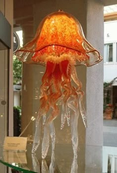 a lamp that is on top of a glass table