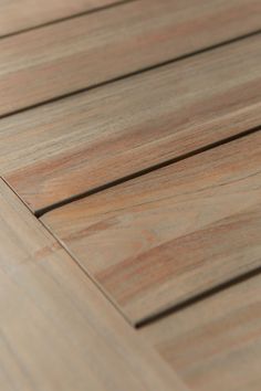 a close up view of the wood flooring on a wooden deck or patio area