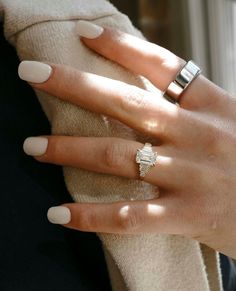 a woman's hand with two rings on it