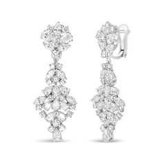 Brimming with the vivacious sparkle of natural, white diamonds, these dazzling drop earrings for her feature marquise, oval, pear, and round shaped diamonds in a prong-setting and arranged in a cluster design. These geometric-inspired cluster earrings form a decadent display of shimmering beauty and are styled for length to capture an eye-catching dangle that catches the light as you move. Fashioned in genuine 18k white gold, the total diamond weight is 9 1/2 carat and the diamonds are of an approximate F-G color and VS1-VS2 clarity. The earrings secure with clip on backs for sizzling nighttime styling. Cluster Design, Geometric Inspiration, Cluster Earrings, Earrings Collection, Diamond Cluster, 2 Carat, White Diamonds, White Gold Diamonds, Diamond White