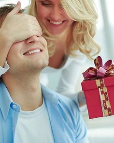 a man giving a woman a present box