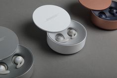 two earbuds are sitting next to each other in their packaging boxes on the table