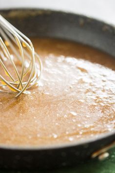 a whisk is being stirred in a skillet