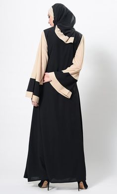 Featuring an elegnat wrap around style color block abaya dress in nida base with contrast color bell shaped crepe fabric sleeves and similar color panel placket placed diagonally on the front. It has a slight A line silhouette perfect for casual everyday wear.FIT : Relaxed fit.COMPOSITION : Nida, crepe.CARE : Dry clean only. Black Abaya With Modesty Panel For Eid, Black Long Abaya With Modesty Panel, A Line Silhouette, Line Silhouette, Mens Items, Abaya Dress, Embroidered Jacket, Crepe Fabric, Womens Tunics