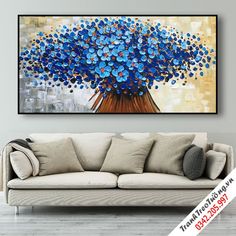 a living room scene with a couch and painting on the wall in blue tones,