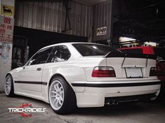 a white car parked in front of a garage