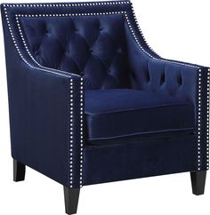 a blue velvet chair with studded trimmings