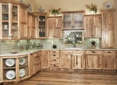 a kitchen with wooden cabinets and green tile backsplash