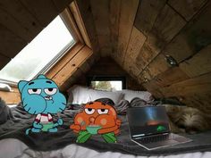 two cartoon characters sitting on top of a bed