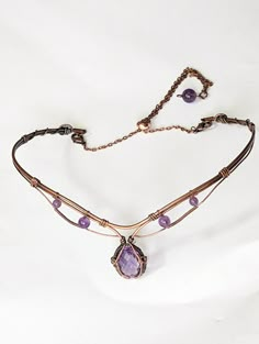 Enhance your look with this stunning 6ct Amethyst choker in copper! Handcrafted with quality materials, this choker features a beautiful Amethyst gemstone in the center, set in copper wire wrap that creates a beautiful and eye-catching design. The copper wire wrap is intricately detailed and flows gracefully around the gemstone, giving it an elegant feel. The choker fits comfortably around the neck and is lightweight enough to be worn all day. You'll be sure to make a bold statement with this un Wire Necklace Patterns, Luxury Wire Wrapped Jewelry Gift, Wire Wrapped Tiara, Wire Wrapped Clasps, Wire Necklace Designs, Wire Choker Necklace Diy, Copper Wire Necklace, Fantasy Wire Jewelry, Wire Wrap Choker