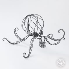 an octopus sculpture made out of wire on a white background with the word art written below it