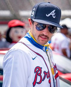 a baseball player wearing sunglasses and a hat