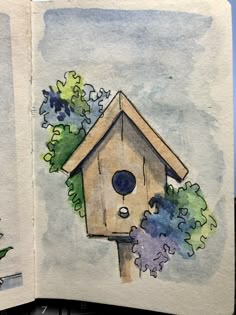 an open book with a drawing of a bird house