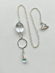 Elegant but simple necklace, sterling silver, gorgeous quartz gemstone and aquamarine gemstones. Necklace measures 18 inches long. All components are sterling silver. Wrapped meticulously in sterling wire, the gemstones are pastel in color and flawless in nature. An amazing sterling, hammered connector adds to the glam of the pendant. Excellent gift idea or treat for yourself! Handmade Silver Aquamarine Necklace, Silver Briolette Blue Topaz Jewelry, Silver Blue Topaz Briolette Jewelry, Handmade Silver Blue Topaz Necklace, Silver Aquamarine Jewelry With Natural Stones, Elegant Silver Necklace With Green Amethyst, Delicate Silver Crystal Necklaces For Jewelry Making, Sterling Silver Necklace With Clear Gemstone, Silver Jewelry With Natural Stones And Blue Topaz