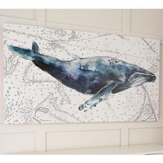 a painting of a whale is hanging on the wall