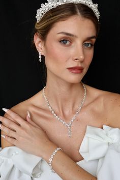 It consists entirely of first class zircon stones. Introducing our exquisite Wedding Jewelry Set, featuring a stunning necklace, ring, and bracelet. Crafted with the finest materials, this set boasts a diamond-like shine that will turn heads wherever you go. Each piece is carefully designed with sparkling, zircon clear stones that mimic the brilliance of real diamonds. The necklace features a delicate chain that gracefully showcases the dazzling centerpiece, while the matching bracelet and ring Elegant Silver Bridal Sets With Rhinestones, Elegant Cubic Zirconia Jewelry For Formal Events, Elegant Cubic Zirconia Wedding Jewelry, Elegant White Gold Jewelry Sets With Cubic Zirconia, Anniversary Jewelry Sets With Cubic Zirconia Round Cut, Crystal Jewelry Sets With Diamond Accents, Exquisite Crystal Jewelry Sets With Diamond Accents, Elegant Crystal Jewelry With Brilliant Cut, Exquisite Crystal Jewelry Sets In Diamond White