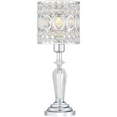 a crystal table lamp with a white shade