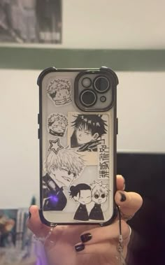 someone is holding up their phone case with anime stickers on it