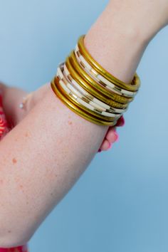 The allure of ivory enamel bangle bracelets is captured in our delicate set of six Veda bangle set for women. Available in a beautiful red & white hue. Combined with other BuDhaGirl bracelets for a modern must-have bracelet set, or create a bracelet stack with an AWB® bracelet set of your choice. Vedas are ancient Hindu texts containing wisdom delivered to priests via hymns, philosophy, and other rituals. Mindful Glamour Ritual: Pause. Breathe. Pick a mantra for your day and repeat it six times White Stackable Bangle Jewelry, White Stackable Bangle, White Bangle Bracelets For Festive Occasions, Adjustable White Bangle For Festive Occasions, Bohemian Cream Bangle Jewelry, Adjustable White Bangle, White Bohemian Bracelets For Festive Occasions, Festive White Bangle Bracelets, Bohemian Cream Bangle