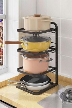 a stack of pots and pans sitting on top of a kitchen counter