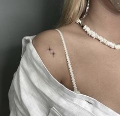 a woman with a star tattoo on her shoulder