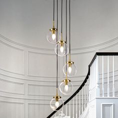 an elegant staircase with chandelier and glass globes