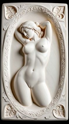 a sculpture of a naked woman in a white frame