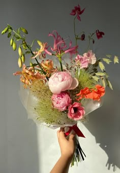 a person holding a bouquet of flowers in their hand