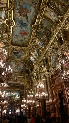 an ornate room with chandeliers and paintings on the ceiling