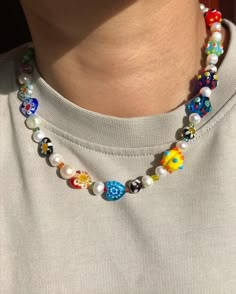 a person wearing a necklace with colorful beads