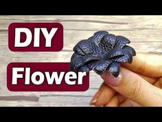 a hand holding a tiny flower in it's left hand with the words diy flower