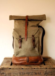 Swiss Army Backpack - Roll Top - from 1950s, made from canvas and leather.   In very good vintage < < < P R O D U C T  D E S C R I P T I O N > > > Perhaps the best military canvas rucksack of all time and certainly the most sought-after, this is the 1950's canvas and leather Swiss Army Backpack . The design was so successful it remained in use for decades even being re-made using a ballistic nylon material as seen in the Swiss Backpack from the 1980's. The Swiss Army Backpack has tough forged an Swiss Backpack, Swiss Army Backpack, Army Backpack, Canvas Rucksack, Roll Top, Waxed Canvas, Top Vintage, Swiss Army, Backpack Purse