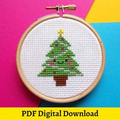 a cross stitch christmas tree on a colorful background with the text free digital embroidery pattern