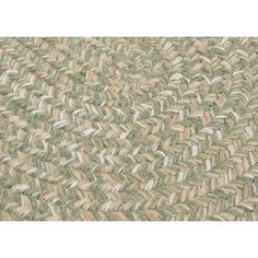 a close up view of a rug with green and white stripes on the bottom half