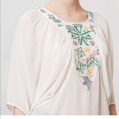 Kashida Dolman From Anthropologie Size S New, With Tags. $178.00 Retail - Style No. 27616440 By Tanvi Kedia Embroidered Neckline Pullover Styling Sheer Rayon Dry Clean Imported Boho, Ethnic Vibe! Necklace Is Not Included Approximate Measurements Are Taken Of Garment Laying Flat/ Unstretched: Bust- Free Size Length (Shoulder To Bottom Hem) 24.5" White Bohemian Embroidered Top For Summer, Bohemian Peasant Top With Embroidered Neckline, Bohemian Flowy Embroidered Summer Top, Flowy Bohemian Embroidered Top For Summer, Flowy Bohemian Embroidered Summer Top, Flowy Bohemian Embroidered Top, White Peasant Top With Boho Collar For Summer, Bohemian Flowy Embroidered Top With Floral Design, Flowy Bohemian Top With Floral Embroidery